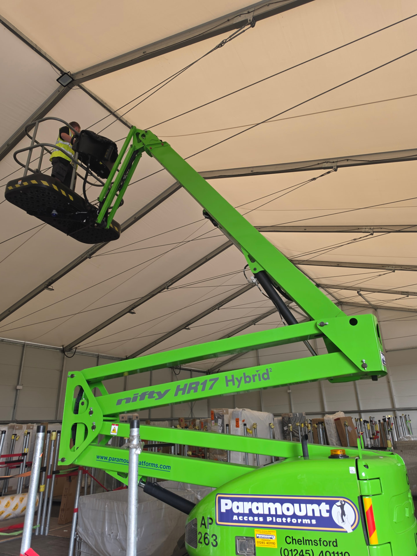 Closer view of the articulated access platform raised to the warehouse roof.