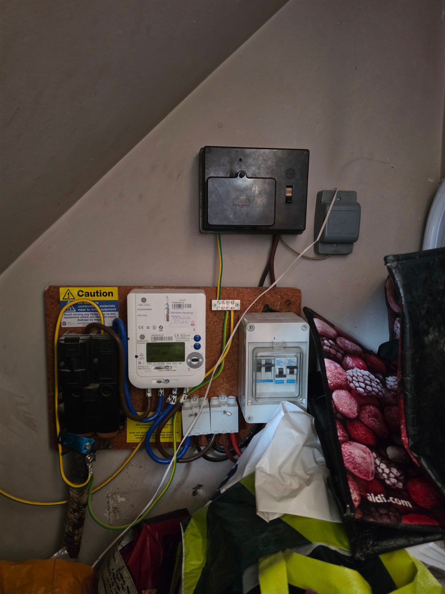 The original fuse box, meter and distribution arrangement before the rewire.