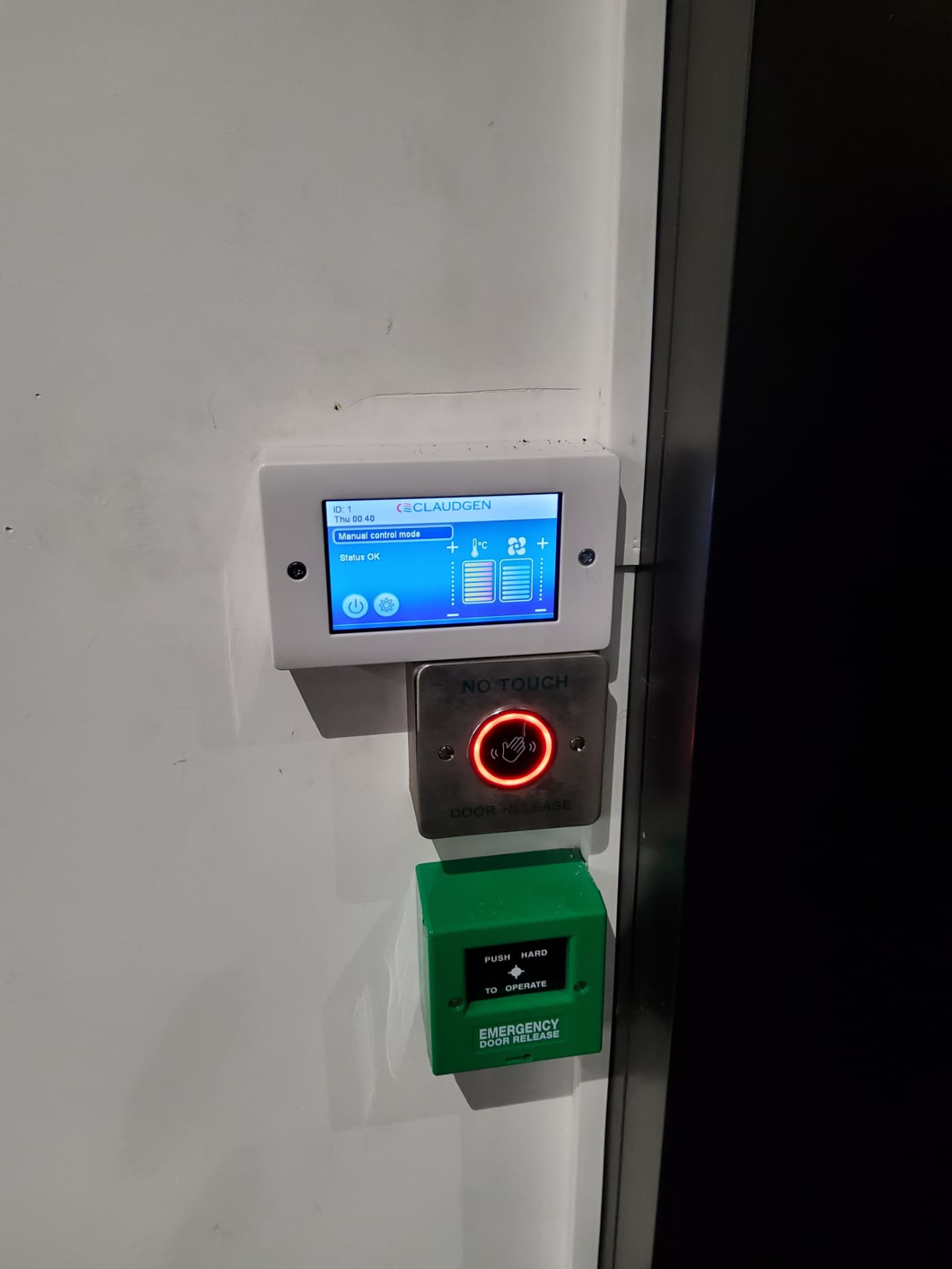 Wall-mounted heater controller showing status OK, beside the door release controls.