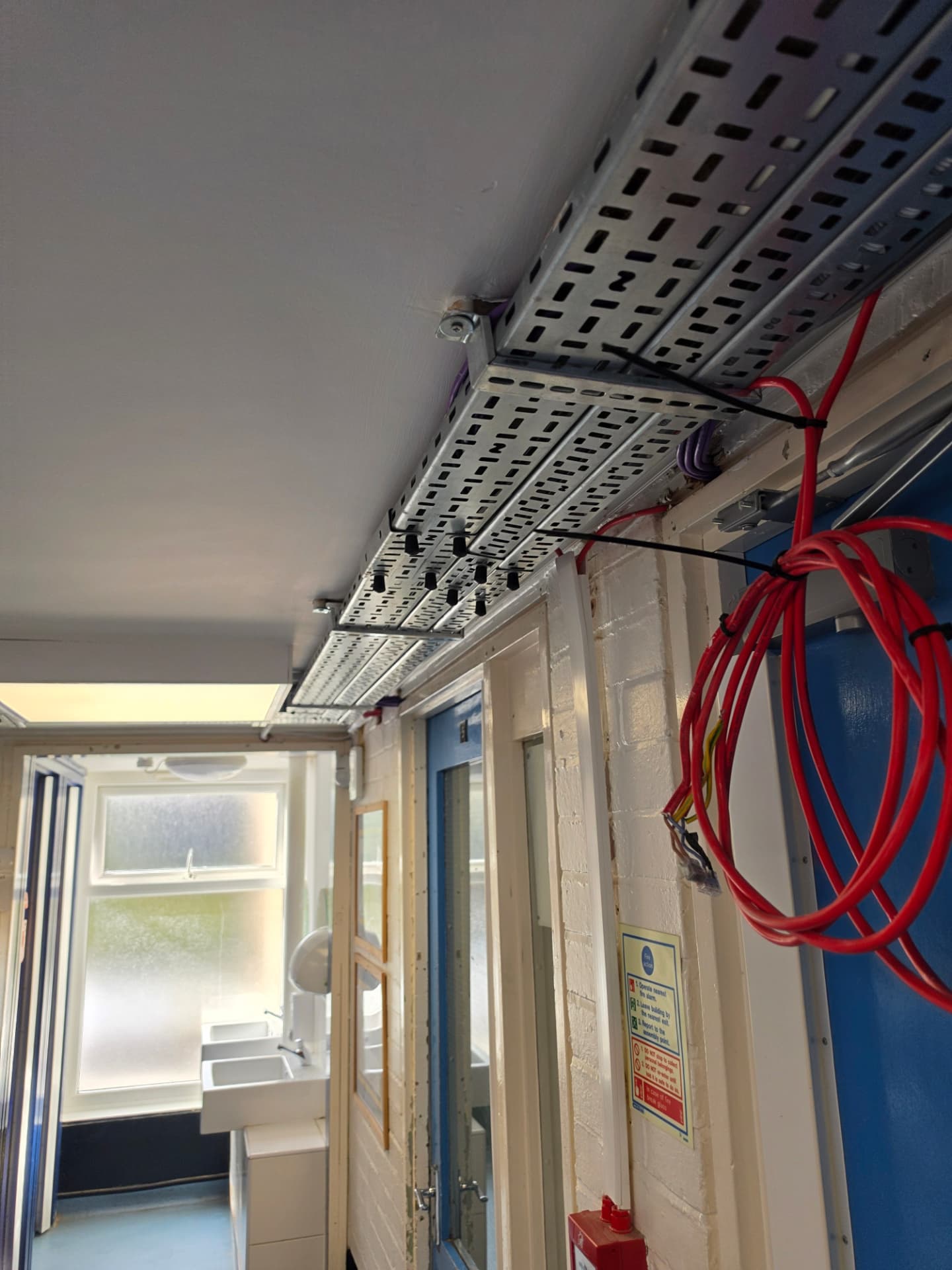 Long perspective view of the installed containment running through the corridor.