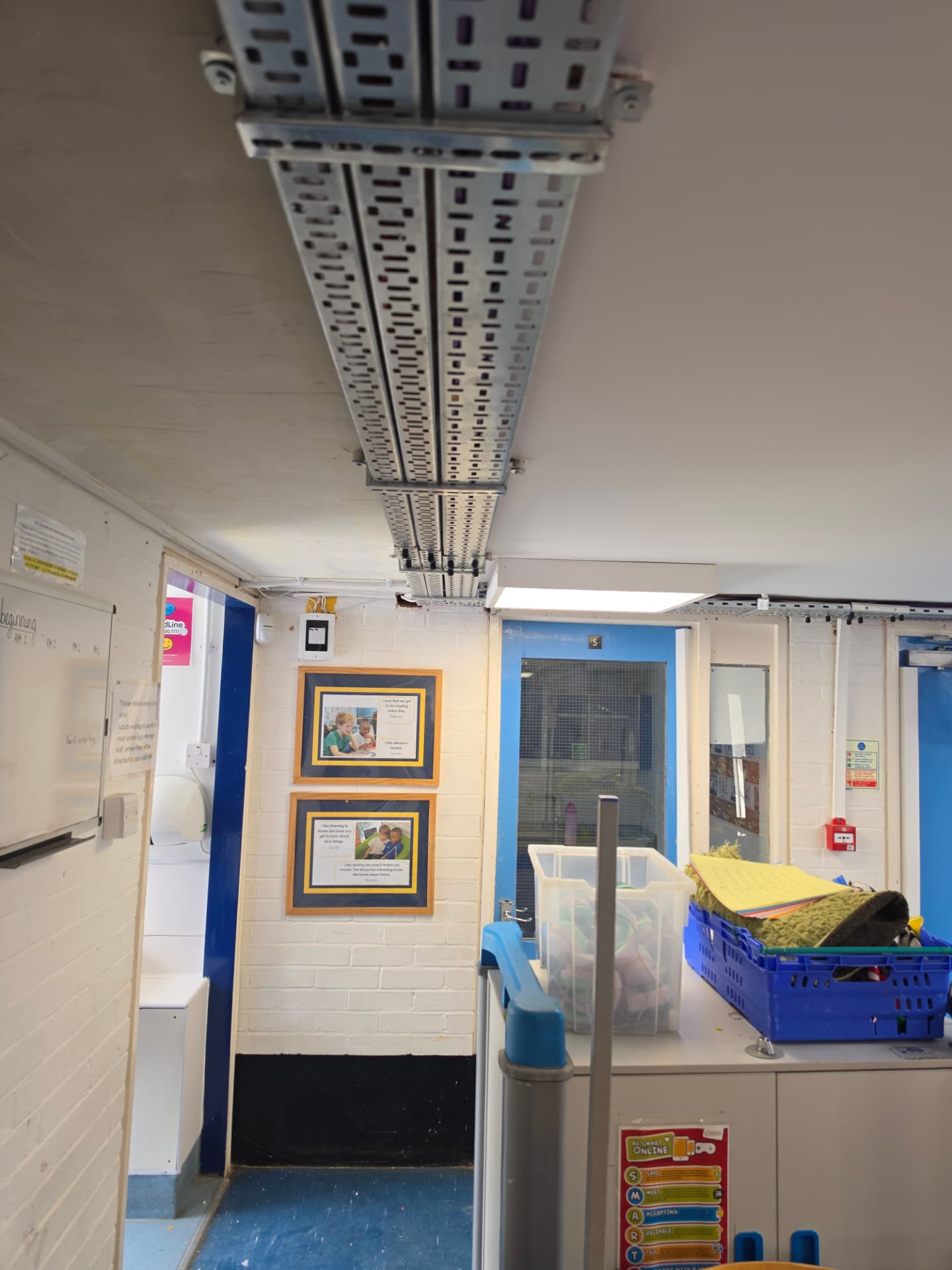 Continuous run of cable tray crossing the corridor ceiling.